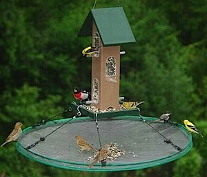 use bird seed trays at whole peanut bird feeders to minimize waste