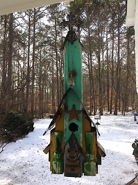decorative bird houses serve as roosting spots
